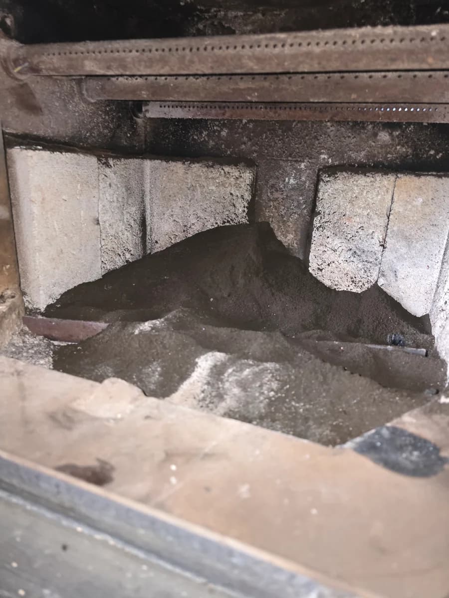 Soot around metal baffle components inside a wood stove