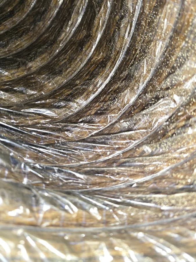 Heavy dust collected along the inner lining of an air duct