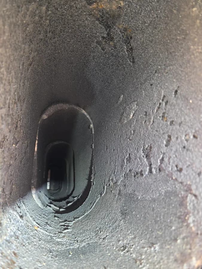 Soot accumulation coating the inside of a chimney flue
