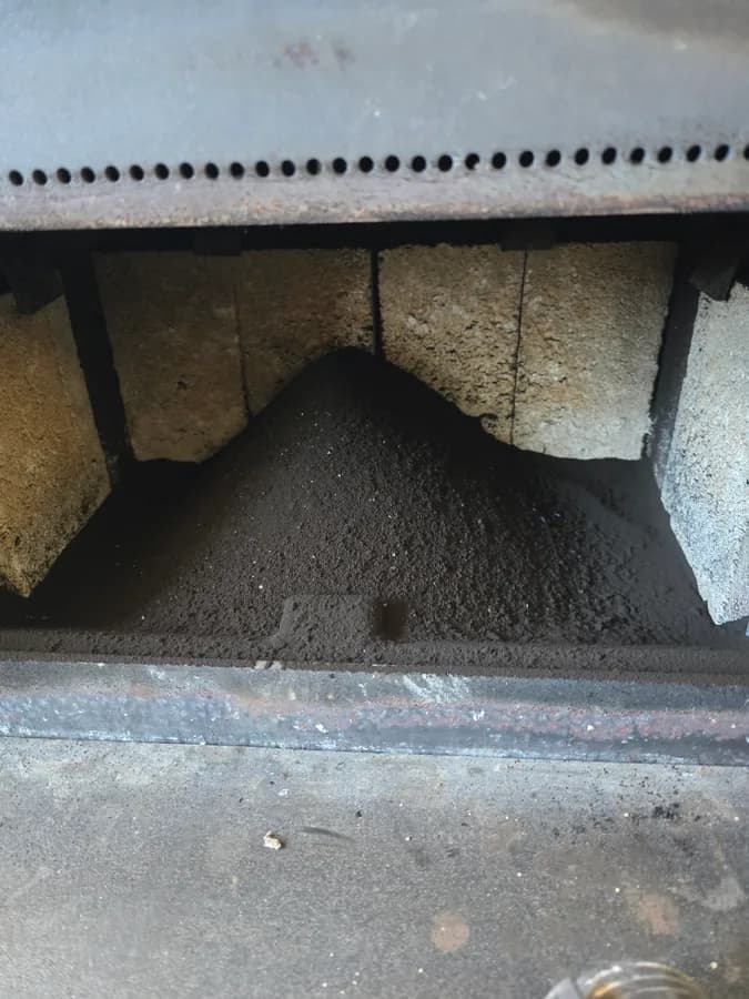 Soot buildup visible inside a wood stove interior